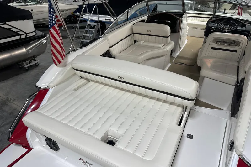 Slide: The Image of 2012 Cobalt A25 boat interior with white leather seating and American flag. - 12