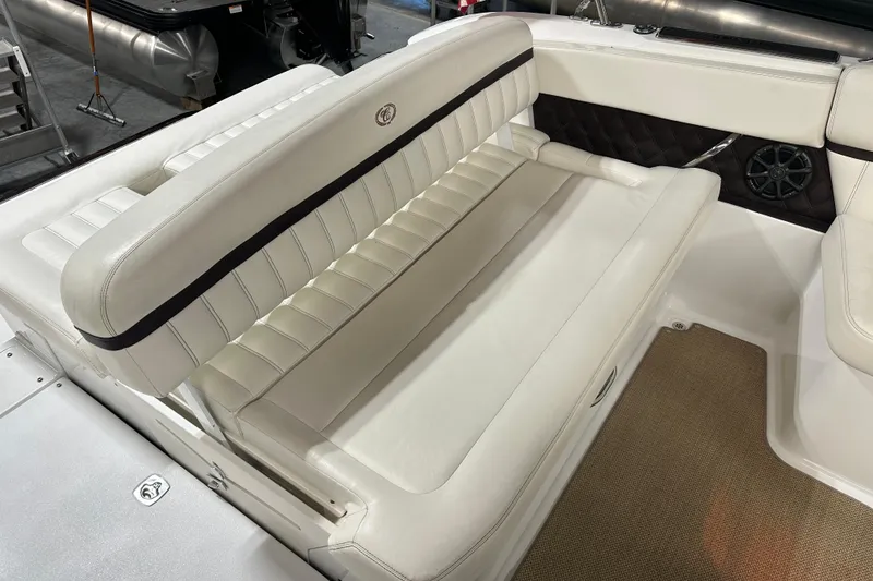 Slide: The Image of 2012 Cobalt A25 boat interior with white leather seating and speaker detail. - 13