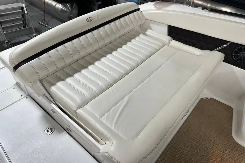 Slide: The Image of White leather seating on a 2012 Cobalt A25 boat interior. - 14