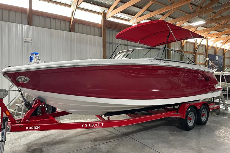 Slide: The Image of Red 2012 Cobalt A25 boat on trailer in indoor storage facility. - 2