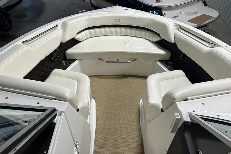 Slide: The Image of Interior of a 2012 Cobalt A25 boat with white seating and carpeted floor. - 24