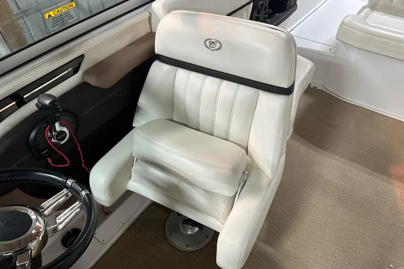 Slide: The Image of Luxurious white captain's chair in 2012 Cobalt A25 boat interior. - 25
