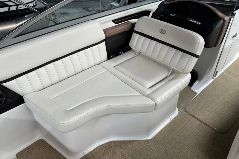 Slide: The Image of Luxurious seating in a 2012 Cobalt A25 boat, featuring elegant white upholstery. - 27