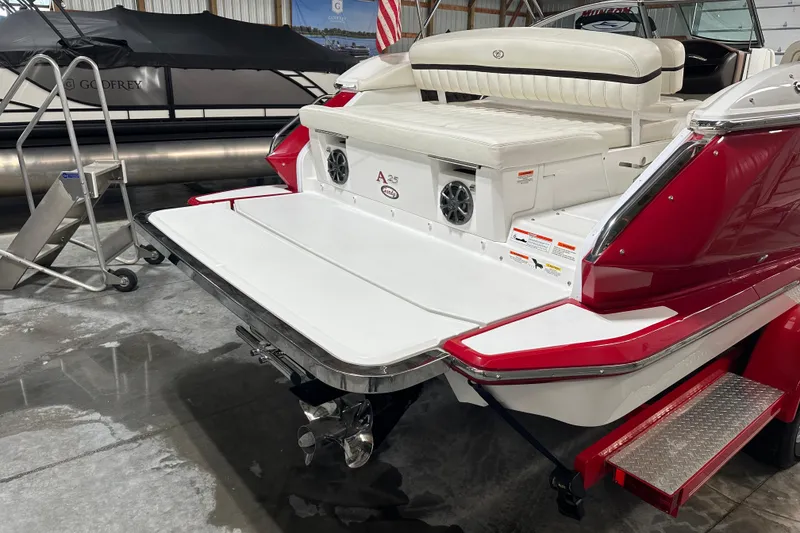 Slide: The Image of 2012 Cobalt A25 boat with red and white design in a showroom. - 5