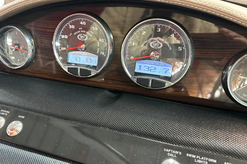 Slide: The Image of Dashboard of a 2012 Cobalt A25 boat showing gauges and engine hours. - 9
