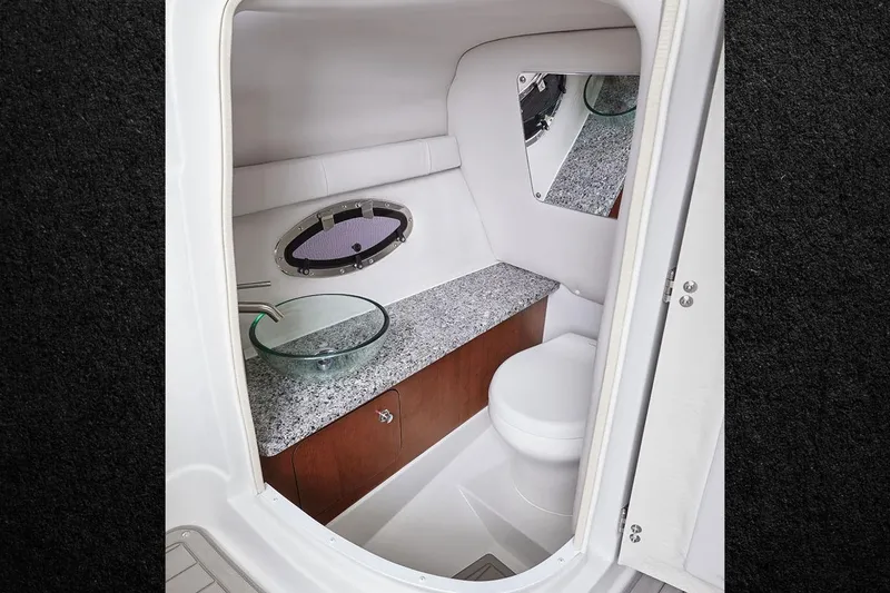 Slide: The Image of 2026 Crownline 270 XSS boat interior bathroom with modern sink and toilet. - 7