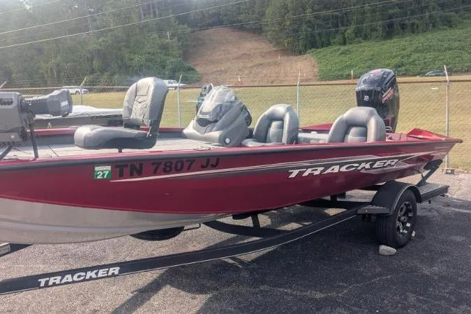 Slide: The Image of 2022 Tracker Pro Team 190 TX Tournament Edition boat, red, on trailer, parked outdoors. - 7