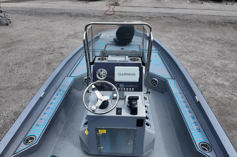 Slide: The Image of 2026 Xpress H22B Bay boat interior with Garmin navigation system and measuring ruler. - 11