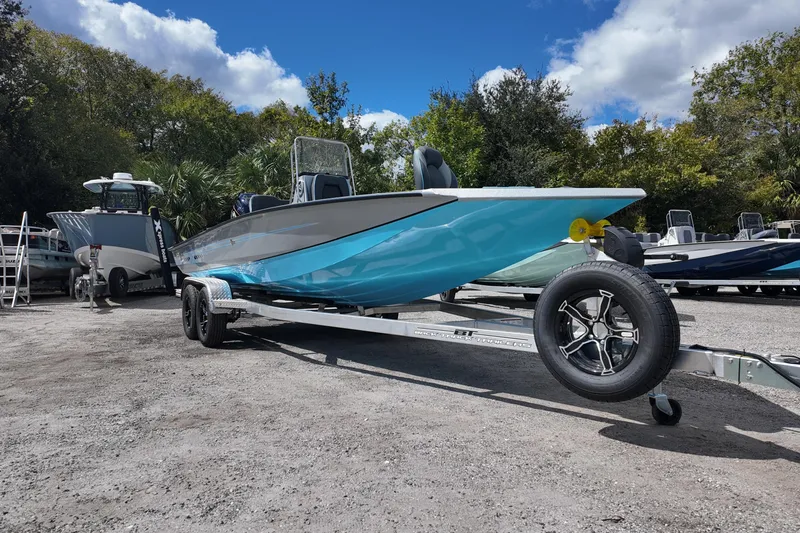 Slide: The Image of 2026 Xpress H22B Bay boat on trailer, parked outdoors under a blue sky. - 4