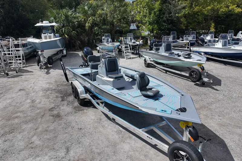 Slide: The Image of 2026 Xpress H22B Bay boat on trailer in outdoor showroom. - 5