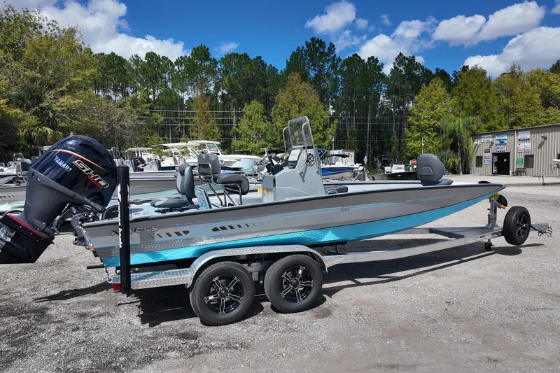 Slide: The Image of 2026 Xpress H22B Bay boat on trailer with Yamaha engine, parked outdoors. - 7