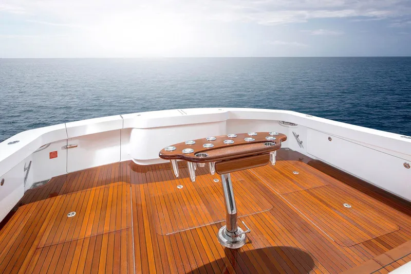 Slide: The Image of Luxurious 2026 Viking 58 Convertible yacht deck with ocean view and polished wood finish. - 11