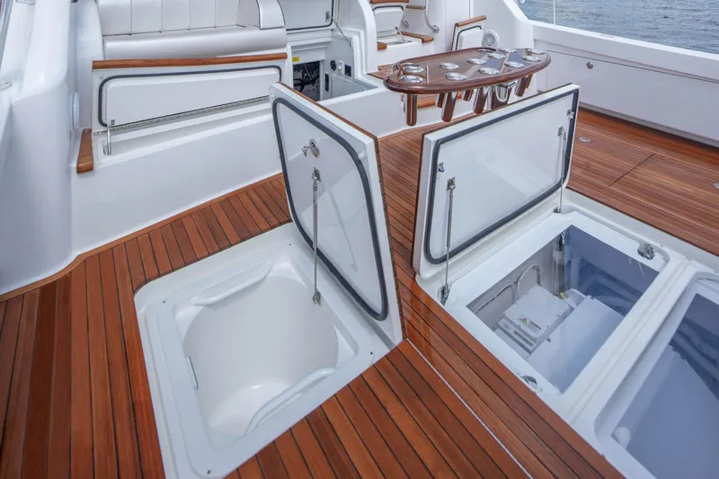 Slide: The Image of 2026 Viking 58 Convertible yacht deck with open storage compartments and seating. - 13