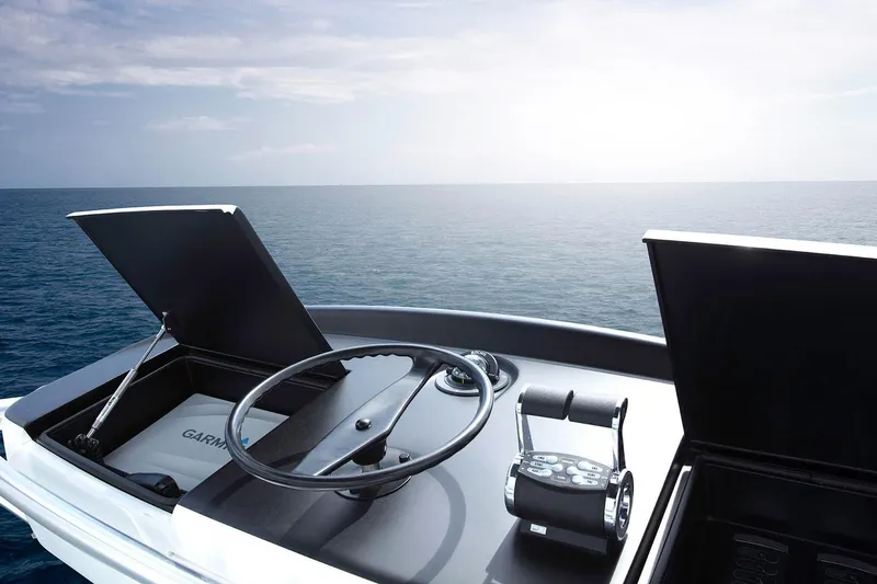 Slide: The Image of 2026 Viking 58 Convertible yacht helm with ocean view, featuring modern controls. - 16