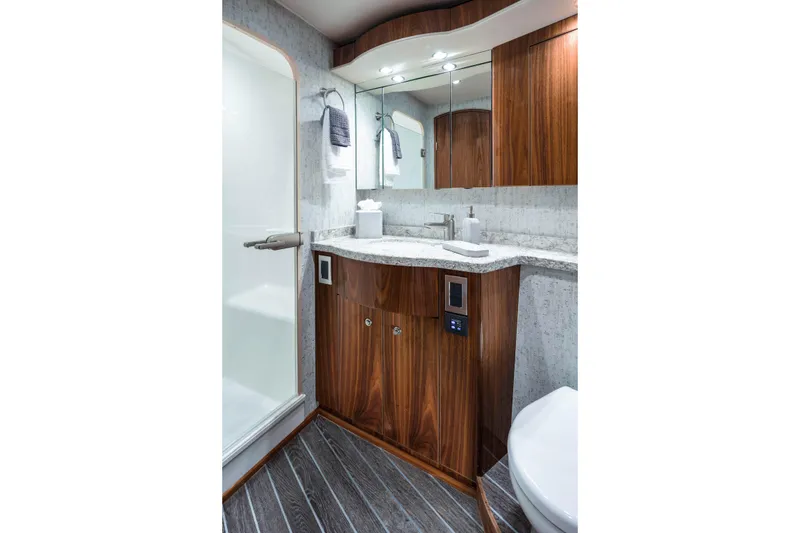 Slide: The Image of Luxurious bathroom in 2026 Viking 58 Convertible yacht with wood cabinetry and modern fixtures. - 23