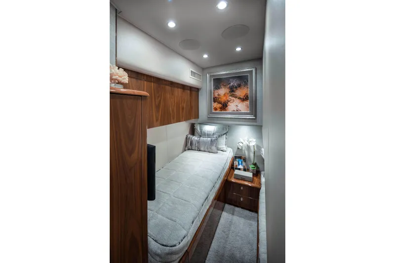 Slide: The Image of Luxurious interior of 2026 Viking 58 Convertible yacht with cozy bed and elegant decor. - 24