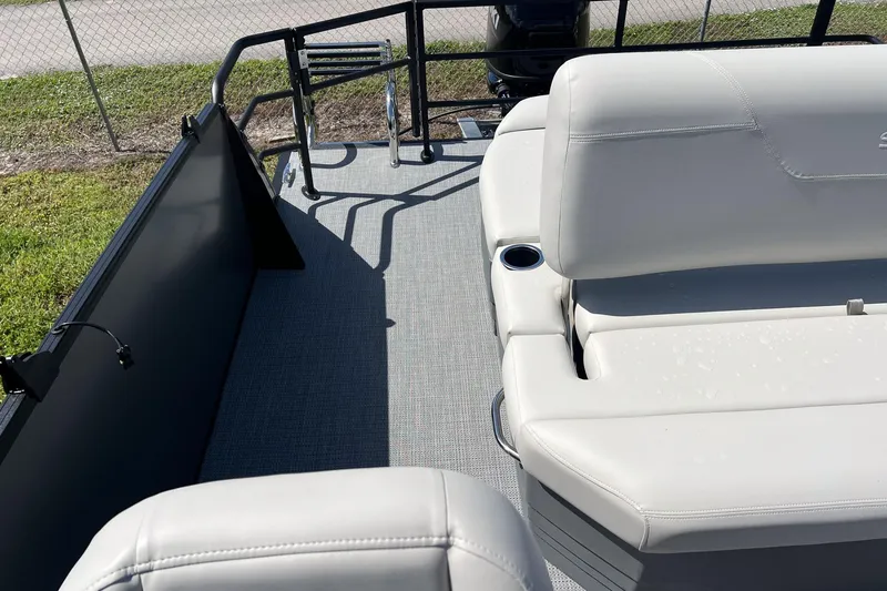 Slide: The Image of 2026 Sylvan Mirage 820 CLZ DH boat interior with white seating and cup holders. - 15