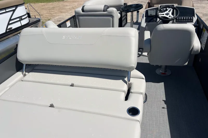 Slide: The Image of 2026 Sylvan Mirage 820 CLZ DH boat interior with plush seating and modern helm. - 17