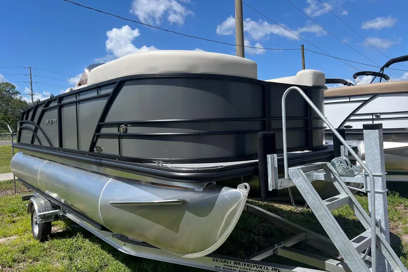 Slide: The Image of 2026 Sylvan Mirage 820 CLZ DH pontoon boat on trailer under blue sky. - 3