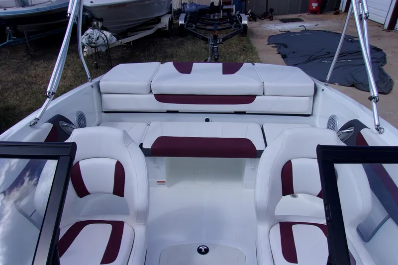 Slide: The Image of 2019 Tahoe 500 TF boat interior with white and maroon seating, showcasing spacious design. - 12
