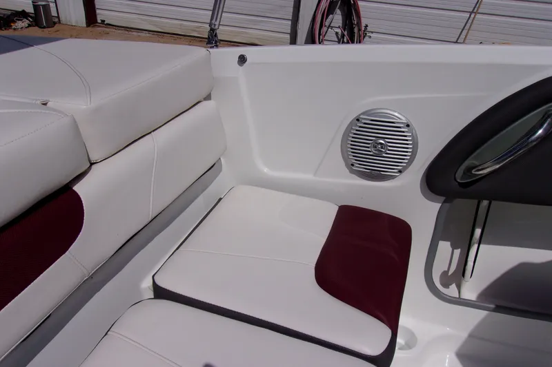 Slide: The Image of 2019 Tahoe 500 TF boat interior with white and maroon seating, speaker, and handle. - 14