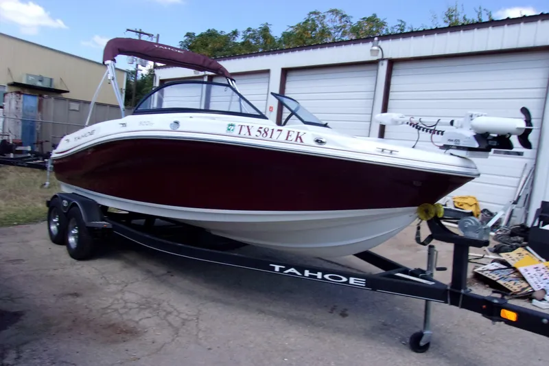 Slide: The Image of 2019 Tahoe 500 TF boat on trailer, parked outside a garage. - 2