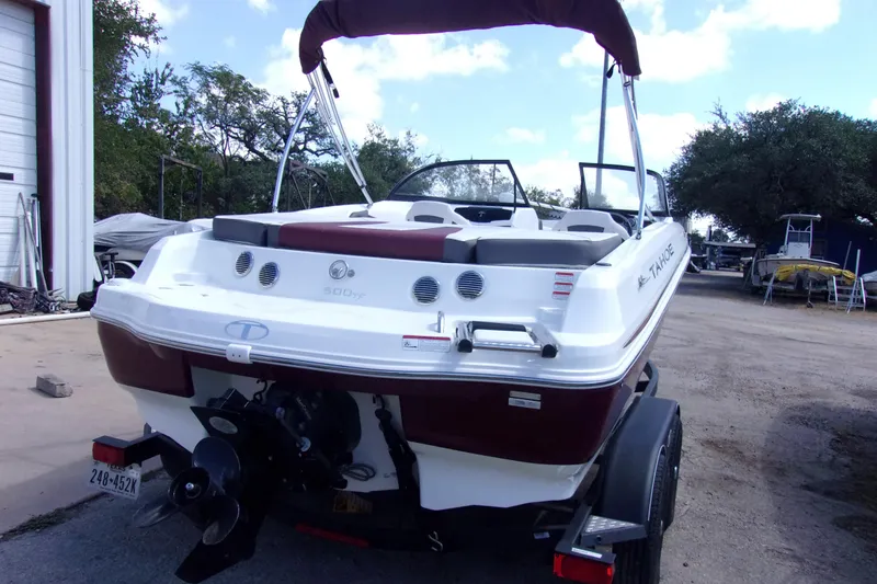 Slide: The Image of 2019 Tahoe 500 TF boat with maroon and white design, parked outdoors. - 3