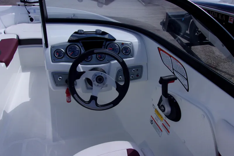 Slide: The Image of 2019 Tahoe 500 TF boat dashboard with steering wheel and control panel. - 5