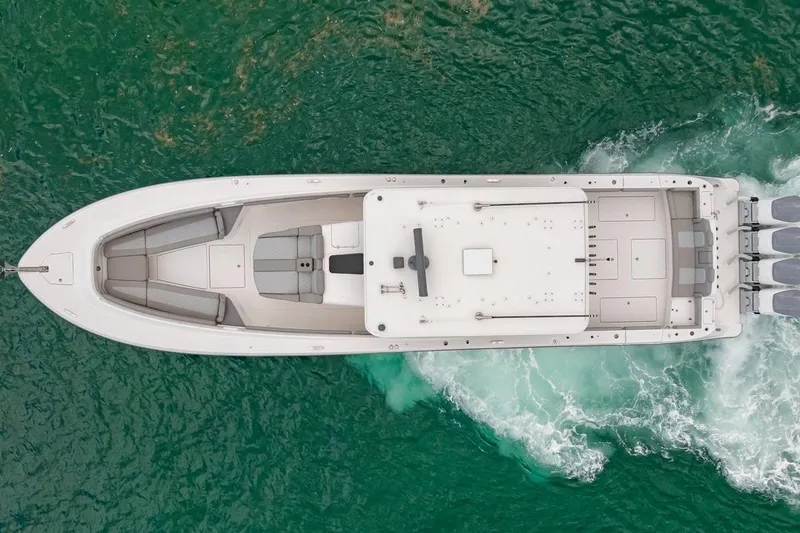 Slide: The Image of Aerial view of 2023 HCB 53 Sueños boat cruising on green water. - 13