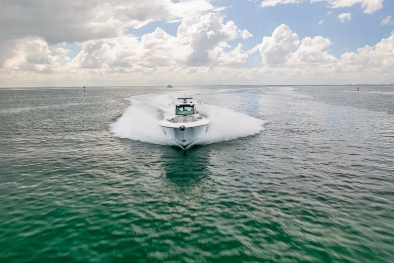 Slide: The Image of 2023 HCB 53 Sueños boat cruising on open water under cloudy sky. - 20