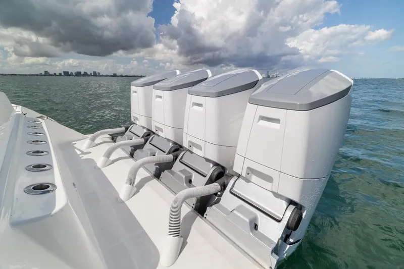 Slide: The Image of 2023 HCB 53 Sueños boat with four powerful outboard engines on open water. - 23