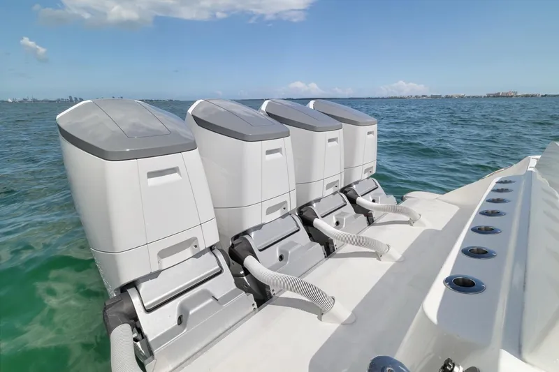 Slide: The Image of Four powerful outboard engines on a 2023 HCB 53 Sueños boat in open water. - 24
