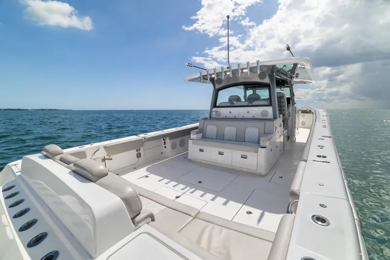 Slide: The Image of 2023 HCB 53 Sueños boat on open water under a clear blue sky. - 25