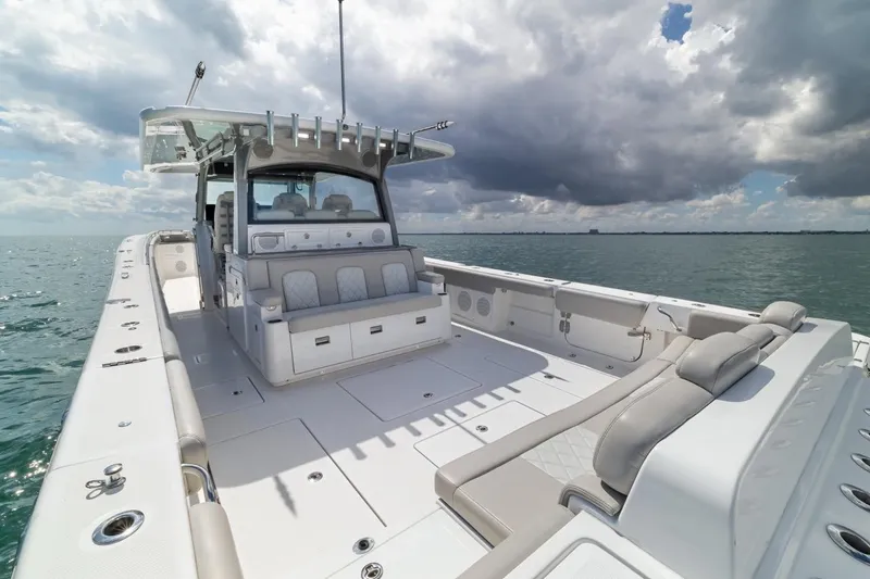 Slide: The Image of 2023 HCB 53 Sueños luxury boat on open water under cloudy sky. - 26