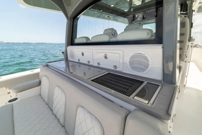 Slide: The Image of Luxury seating and grill area on 2023 HCB 53 Sueños boat. - 32
