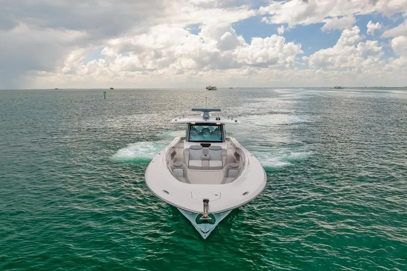 Slide: The Image of 2023 HCB 53 Sueños boat cruising on open water under a cloudy sky. - 4