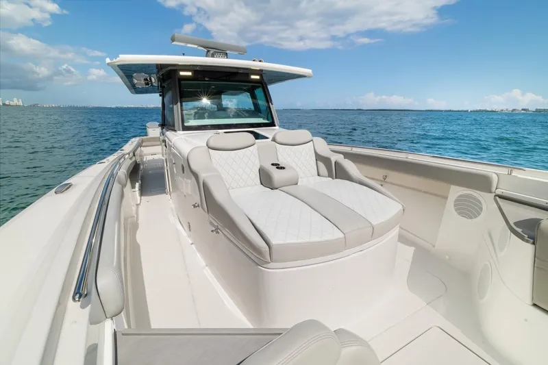 Slide: The Image of Luxury 2023 HCB 53 Sueños boat with elegant seating on open water. - 40