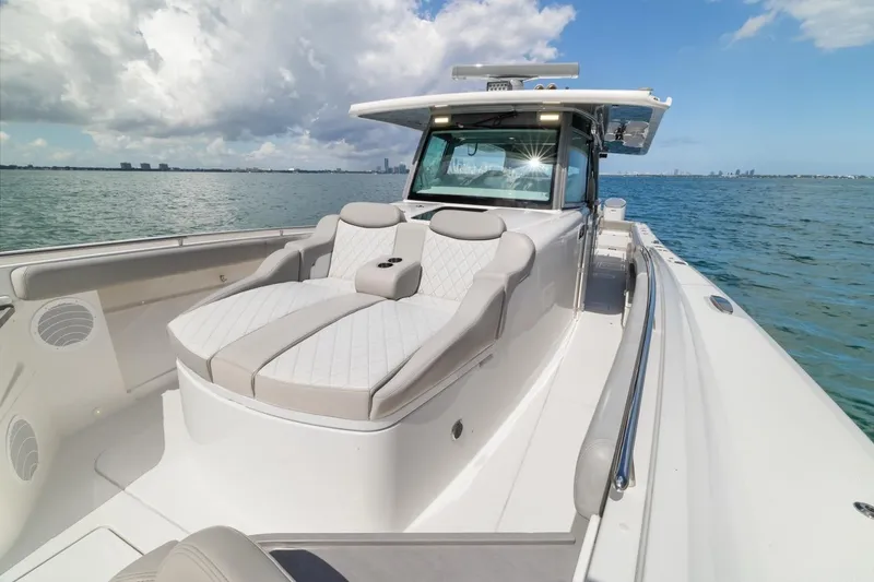 Slide: The Image of 2023 HCB 53 Sueños luxury boat on calm waters under a partly cloudy sky. - 41