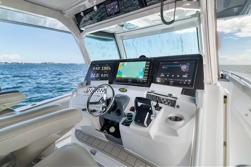 Slide: The Image of 2023 HCB 53 Sueños boat cockpit with advanced navigation and control systems. - 44