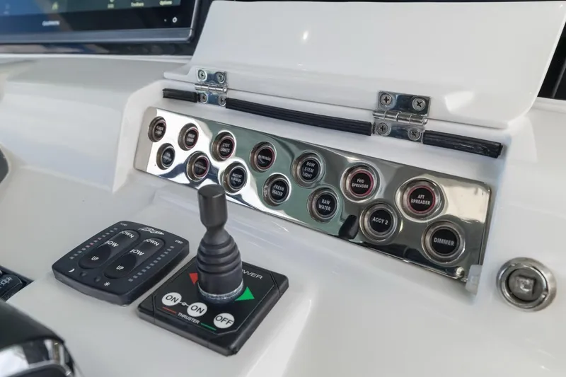 Slide: The Image of Control panel of 2023 HCB 53 Sueños boat with switches and joystick. - 48