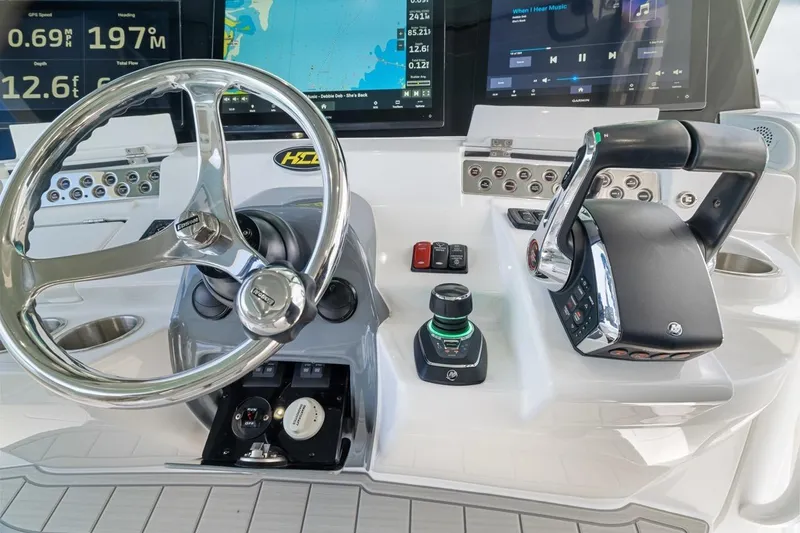 Slide: The Image of 2023 HCB 53 Sueños helm with advanced controls and navigation displays. - 49