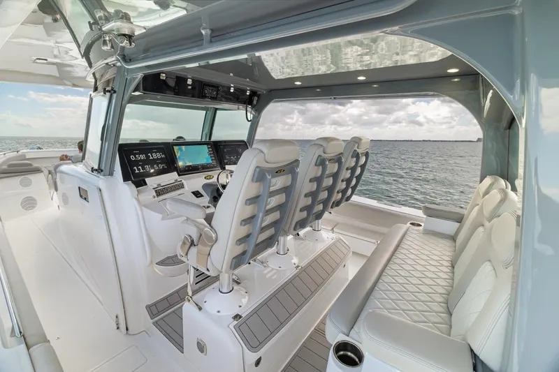 Slide: The Image of 2023 HCB 53 Sueños boat interior with modern helm and luxurious seating. - 53