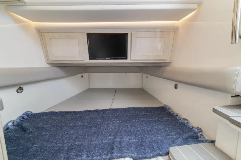 Slide: The Image of 2023 HCB 53 Sueños cabin interior with TV and blue rug. - 56