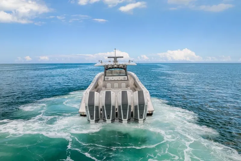 Slide: The Image of 2023 HCB 53 Sueños luxury boat cruising on open ocean waters. - 6
