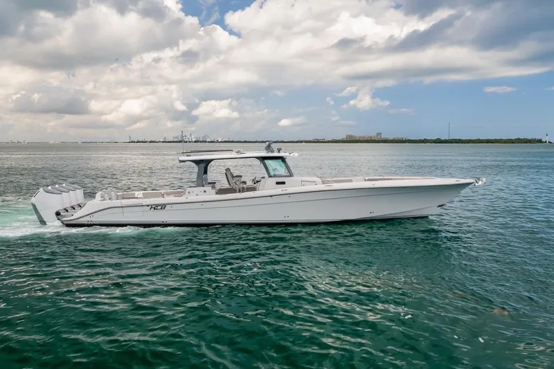 Slide: The Image of 2023 HCB 53 Sueños boat cruising on open water under a cloudy sky. - 8