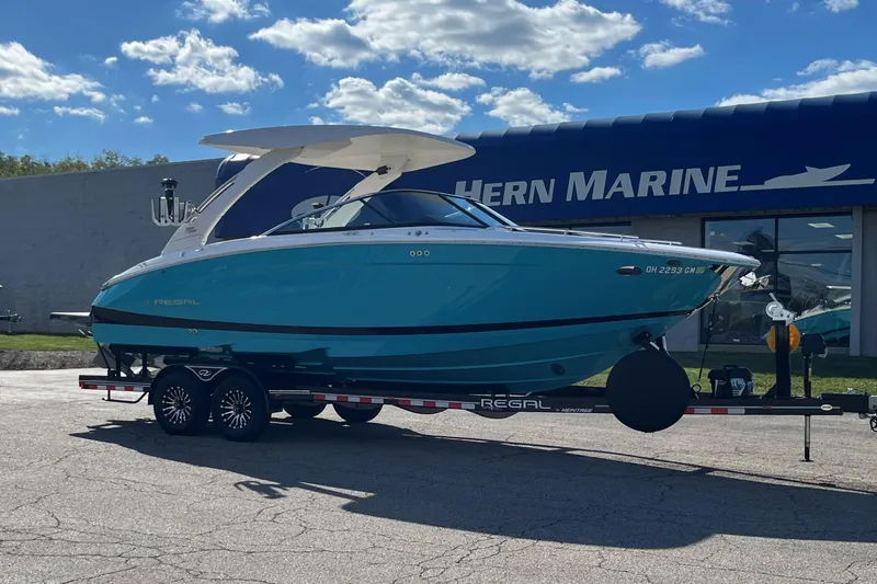 The Image of 2024 Regal LS9 Surf boat on trailer outside Hern Marine dealership. - 0