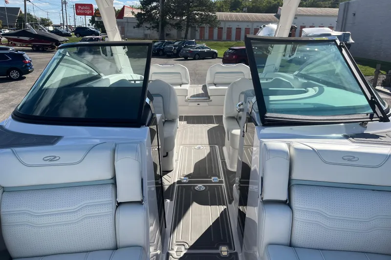Slide: The Image of 2024 Regal LS9 Surf boat interior with white seating and open windshield. - 10