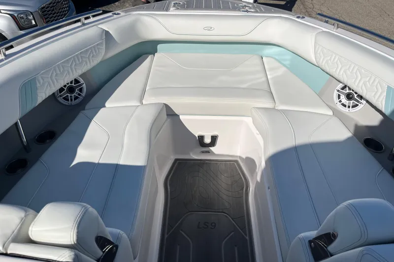 Slide: The Image of 2024 Regal LS9 Surf boat interior with white seating and modern design. - 11