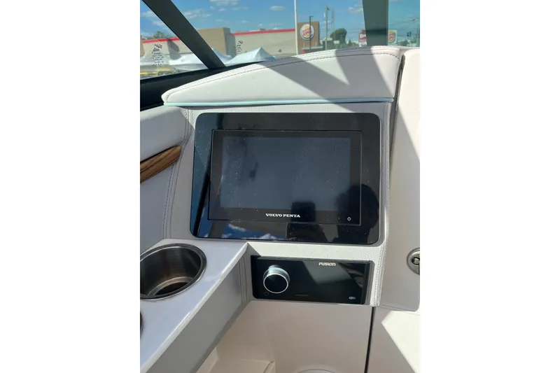 Slide: The Image of 2024 Regal LS9 Surf boat dashboard with Volvo Penta display and Fusion audio system. - 16