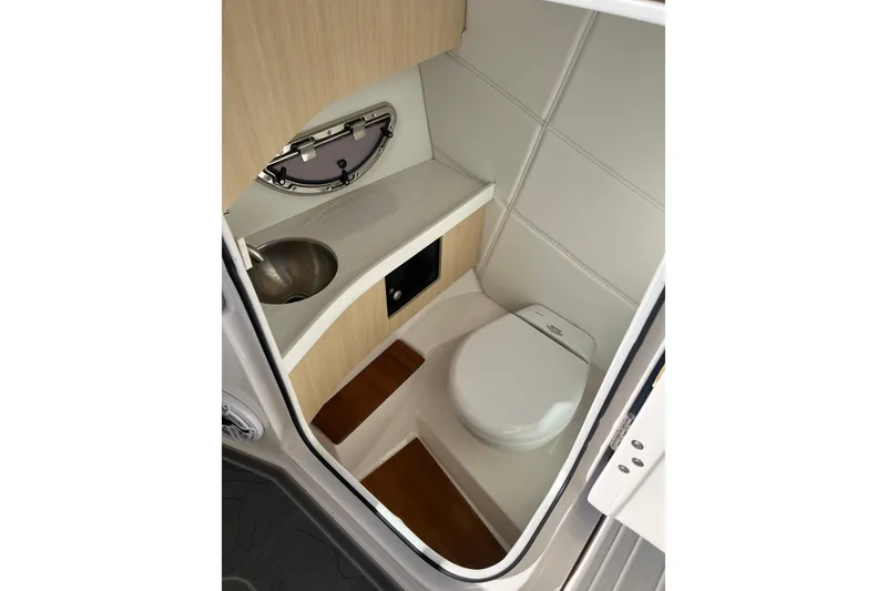 Slide: The Image of 2024 Regal LS9 Surf boat interior bathroom with sink and toilet. - 21